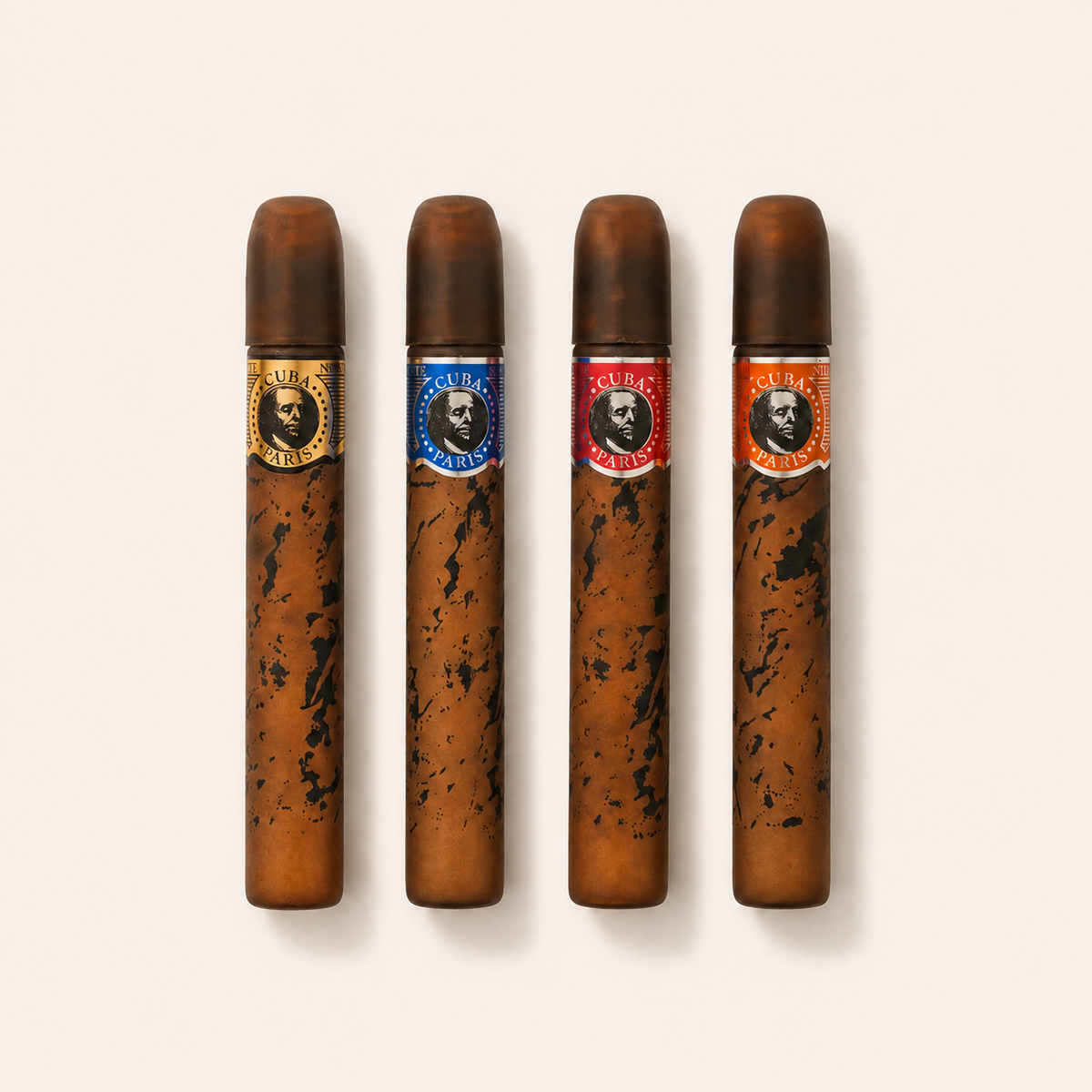 Čtyři miniatury pánských toaletních vod Cuba Gold, Blue, Red a Orange po 5 ml na světlém pozadí – MrRizz
